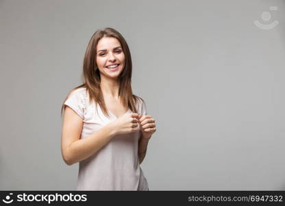 Portrait of beautiful brunette woman with natural make-up, on grey background. Portrait of beautiful brunette woman with natural make-up, on grey background.