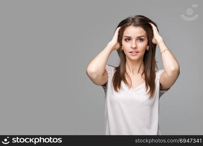 Portrait of beautiful brunette woman with natural make-up, on grey background. Portrait of beautiful brunette woman with natural make-up, on grey background.