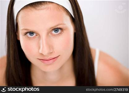 Portrait of beautiful brunette woman with white headband