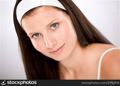 Portrait of beautiful brunette woman with white headband