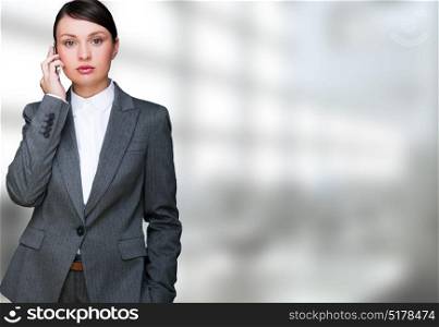 Portrait of beautiful business woman on the phone at her office