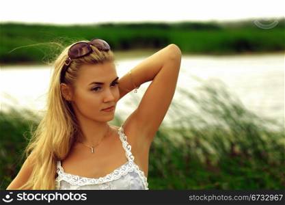 Portrait of beautiful caucasian woman on nature, cane field