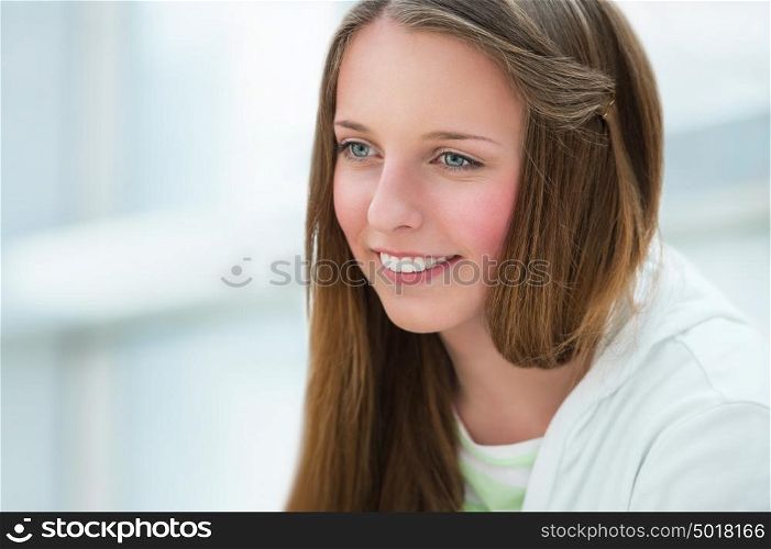 Portrait of beautiful caucasian young girl at campus. Copyspace