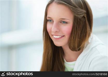 Portrait of beautiful caucasian young girl at campus. Copyspace