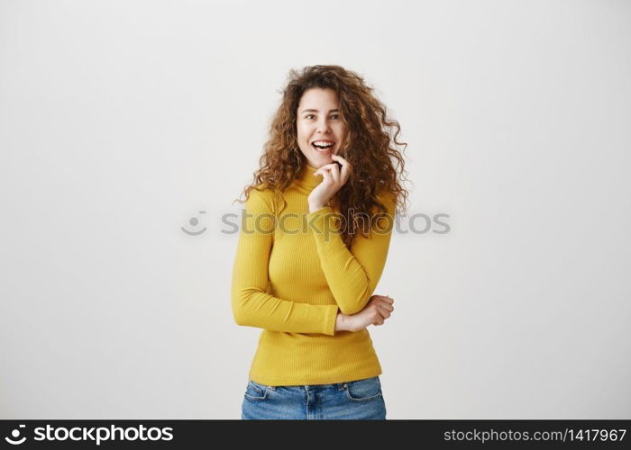 Portrait of beautiful cheerful redhead girl with curly hair smiling laughing looking at camera over white background. Portrait of beautiful cheerful redhead girl with curly hair smiling laughing looking at camera over white background.