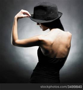 Portrait of beautiful dancing girl in hat