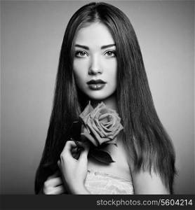 Portrait of beautiful dark-haired woman with flowers. Black and White photo