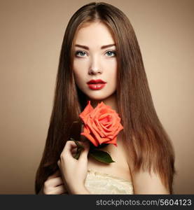 Portrait of beautiful dark-haired woman with flowers. Fashion photo