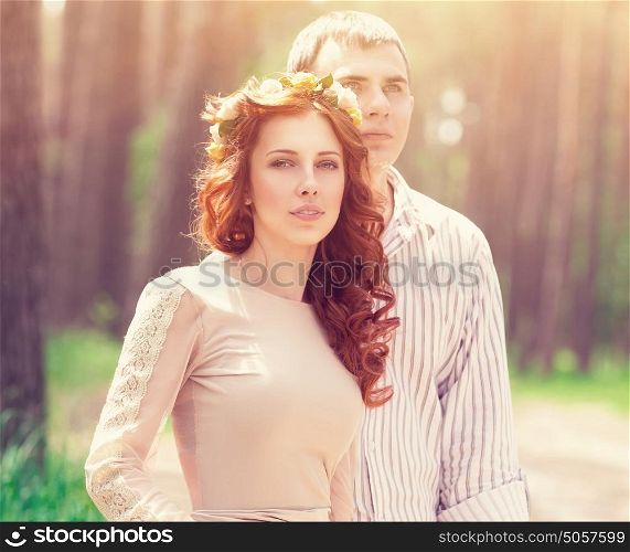 Portrait of beautiful dreamy couple in the forest in bright sunny day, wedding celebration, romantic relationship, love and fashion concept