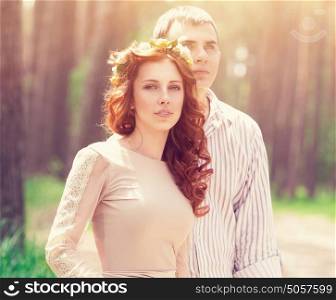 Portrait of beautiful dreamy couple in the forest in bright sunny day, wedding celebration, romantic relationship, love and fashion concept