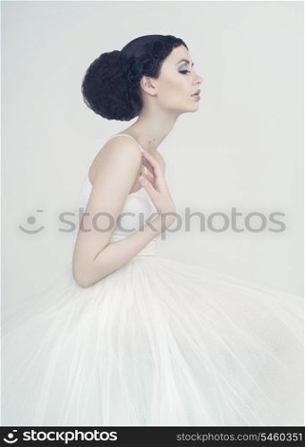 Portrait of beautiful elegant ballerina on white background