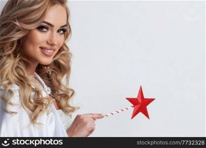 Portrait of beautiful fairy woman with star shaped magic wand over white background with copy space for text. Fairy woman with star magic wand