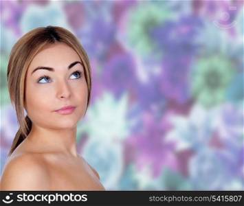 Portrait of beautiful female model looking up with a floral background