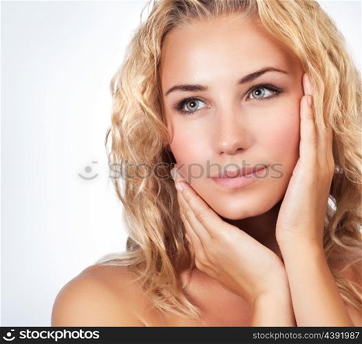 Portrait of beautiful gentle blond woman over clean background, using natural cosmetics in spa salon, beauty treatment