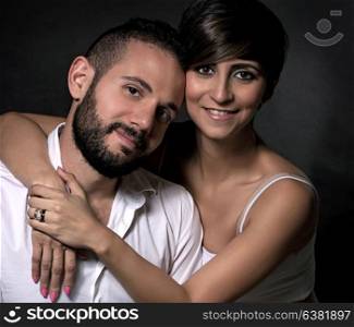 Portrait of beautiful gentle lovely couple over black background, romantic relationship, gentle feelings to each other, love and happy lifestyle concept