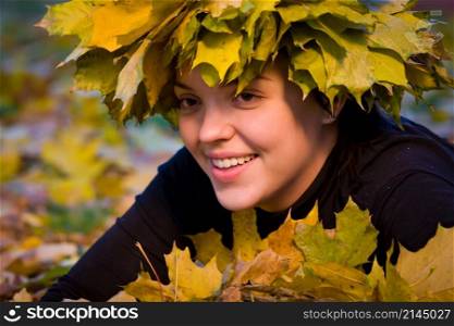 Portrait of beautiful girl in wreath of leaves. girl in wreath of leaves
