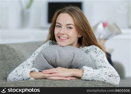 portrait of beautiful girl laying on sofa smiling
