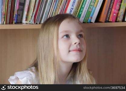 Portrait of beautiful girl on book background
