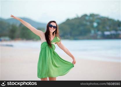 Portrait of beautiful girl on the beach. Young beautiful woman having fun on tropical seashore.