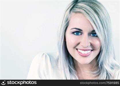 Portrait of beautiful girl or young woman smiling with perfect teeth and bright blue eyes