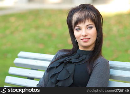 Portrait of beautiful girl sitting on the bench