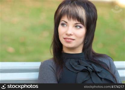 Portrait of beautiful girl sitting on the bench
