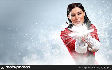 Portrait of beautiful girl wearing santa claus clothes on red background