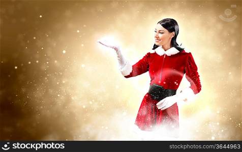 Portrait of beautiful girl wearing santa claus clothes on red background