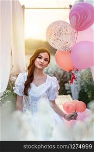 portrait of beautiful girl with balloon in nature field. beautiful girl with balloon in nature field