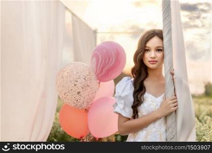 portrait of beautiful girl with balloon in nature field. portrait of beautiful asian woman in nature flowers