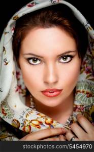 Portrait of beautiful girl with old russian shawl on head on black background. Retouched&#xA;