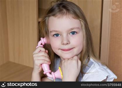 Portrait of beautiful girl with pink telephone