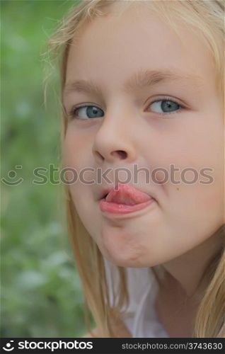Portrait of beautiful girl with put out tongue
