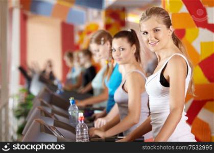 Portrait of beautiful girls on warm-up in sports hall