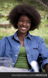 Portrait of Beautiful happy African-American girl sitting outside