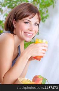 Portrait of beautiful happy brunette woman drinking tasty fresh juice on at home, having breakfast, organic nutrition, healthy lifestyle concept