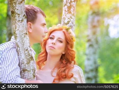 Portrait of beautiful happy couple in love, standing and hugging between birch trees, enjoying wedding day, romantic relationship concept