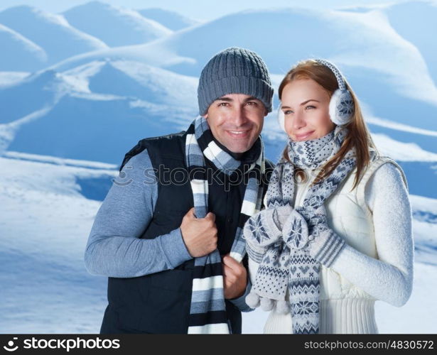Portrait of beautiful happy couple spending time in snowy mountains, with pleasure spending winter holidays outdoors&#xA;