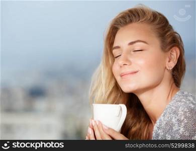 Portrait of beautiful happy girl with closed eyes, enjoying tasty strong morning coffee aroma, having breakfast in outdoor cafe