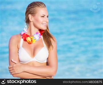 Portrait of beautiful happy woman on the beach party, wearing traditional Hawaiian necklace of flowers, amazing summer vacation