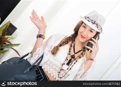 portrait of beautiful hippie girl with a smartphone