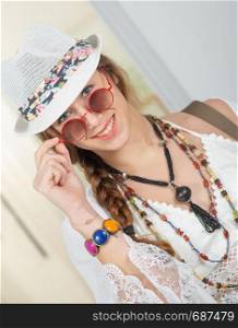 portrait of beautiful hippie girl with a white summer hat