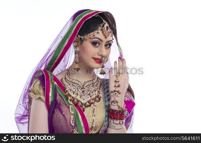 Portrait of beautiful Indian bride against white background