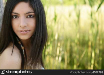 Portrait of beautiful indian woman on nature, cane field
