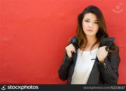 Portrait of beautiful japanese woman in urban background wearing leather jacket