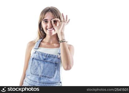 Portrait of beautiful joyful blonde Caucasian female smiling, demonstrating white teeth, looking at the camera through fingers in okay gesture. Face expressions, emotions, and body language