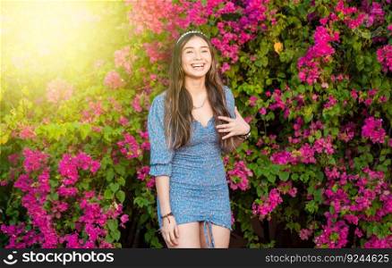 Portrait of beautiful latin girl smiling in a flower garden. happy young latin woman smiling in the garden