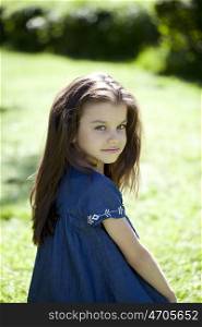 Portrait of beautiful little girl in summer park