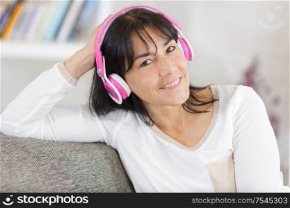 portrait of beautiful mature woman smiling with headphones