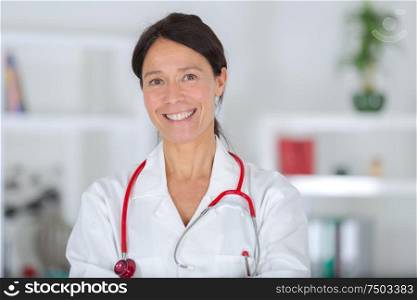 portrait of beautiful middle aged female doctor smiling